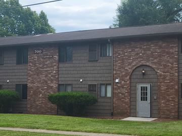 Akron apartment for rent - the front of a brick building with a blue door