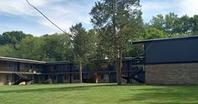 Akron apartment for rent - a row of houses with a grass yard and trees