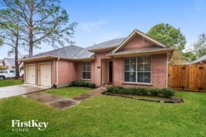 Houston house for rent - A brick house with a white car parked in the driveway.