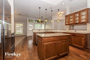 Houston house for rent - A modern kitchen with wooden cabinets and a marble countertop.