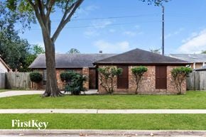Houston house for rent - a small brick house with a yard and a tree
