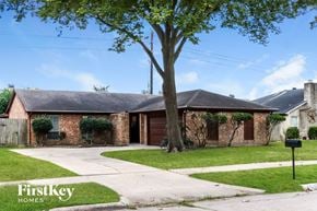 Houston house for rent - a small brick house with a tree in the front