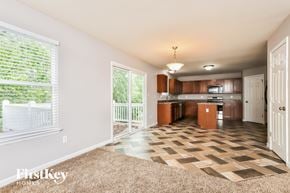 Lake St Louis house for rent - A living room with a checkered floor and a sliding glass door.