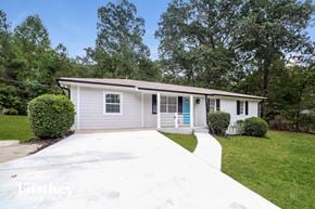 Covington house for rent - a white bungalow with a white driveway and a blue door