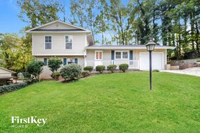 Marietta house for rent - a white house with a lawn and a lamp post