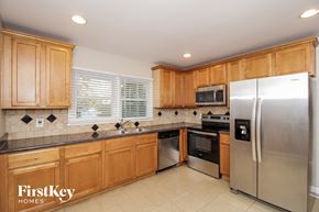 Marietta house for rent - a kitchen with wooden cabinets and stainless steel appliances