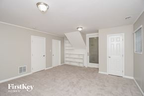 Marietta house for rent - a bedroom with a carpeted floor and white doors and a staircase