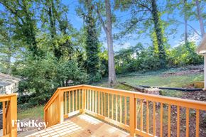 Marietta house for rent - a deck with a yard and trees in the background