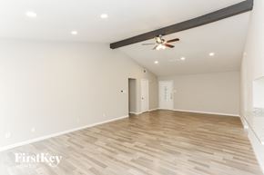 Fort Worth house for rent - A spacious room with wooden flooring and a ceiling fan.