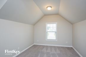 Cumming house for rent - the bedroom has a vaulted ceiling and a window