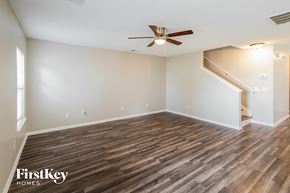 Summerville house for rent - A room with wooden flooring and a ceiling fan.