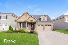 Mooresville house for rent - a house with a driveway and a lawn