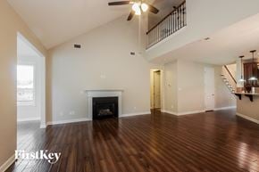 Mooresville house for rent - an empty living room with a fireplace and a staircase