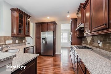 Mooresville house for rent - a kitchen with wood cabinets and granite counter tops and a stainless steel refrigerator