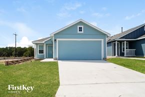 San Antonio house for rent - a blue house with a driveway and a blue garage door