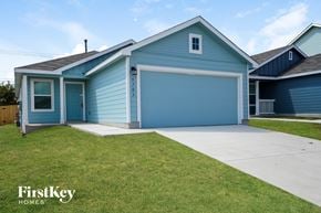 San Antonio house for rent - a blue house with a driveway and a blue garage door
