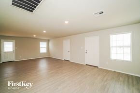 San Antonio house for rent - the spacious living room with wood flooring and white walls
