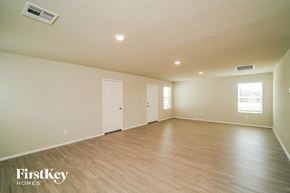 San Antonio house for rent - the spacious living room with hardwood flooring and white walls