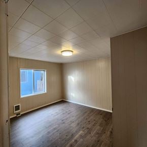 Longview house for rent - the living room of an empty house with wood floors and a window