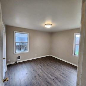 Longview house for rent - an empty room with wooden floors and a window