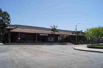 Covina apartment for rent - a building with a parking lot in front of it
