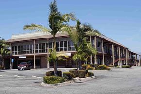 Covina apartment for rent - an office building with palm trees in the parking lot