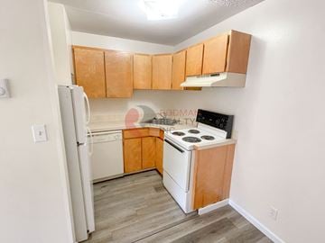 Longview apartment for rent - A kitchen with wooden cabinets and a white fridge.