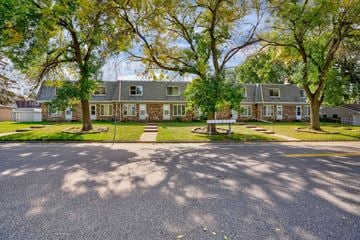 Maplewood townhouse for rent - a house with trees in front of it on a street