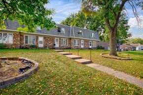 Maplewood townhouse for rent - the front of a house with a tree and a sidewalk