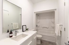 Winnipeg apartment for rent - A white bathroom with a sink, toilet, and bathtub.