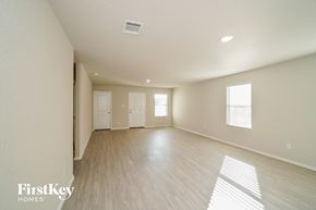 Converse house for rent - an empty living room with wood floors and white walls