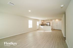 Converse house for rent - an empty living room and kitchen with wood flooring