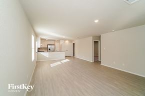 Converse house for rent - an empty living room and kitchen with wood flooring