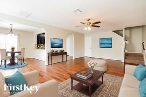 Rosenberg house for rent - A living room with a couch, a coffee table, and a television.