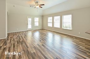 Cypress house for rent - the living room with hardwood floors and a ceiling fan