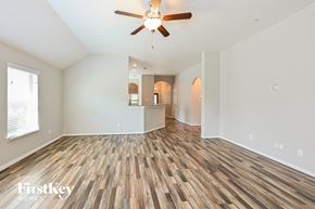 Cypress house for rent - the living room and dining room with wood flooring and ceiling fan
