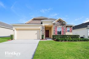 Haines City house for rent - A house with a garage and a driveway in front of it.