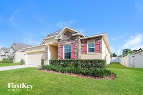 Haines City house for rent - A house with a red window and a sign that says FirstKey Homes.