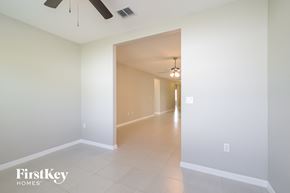 Haines City house for rent - A spacious hallway with a fan and light fixture.