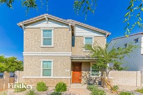 Mesa house for rent - a beige house with a orange door