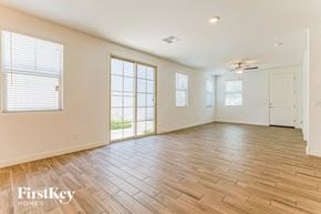 Mesa house for rent - an empty living room with wood flooring and a window