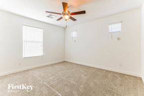 Mesa house for rent - a bedroom with a ceiling fan and a carpeted floor