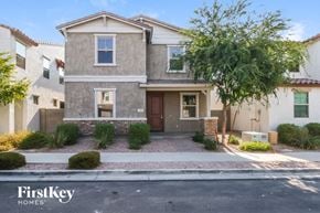 Mesa house for rent - A house with a brown door and a brick wall in front.