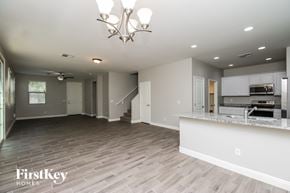 Mesa house for rent - A spacious living room with a kitchen area in the background.