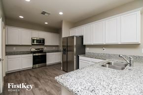 Mesa house for rent - A kitchen with granite countertops and stainless steel appliances.