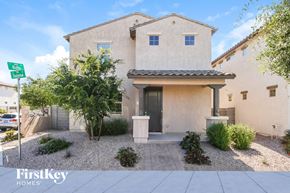 Mesa house for rent - a house with a driveway and a street sign in front of it