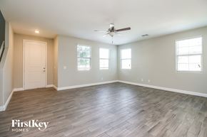 Mesa house for rent - the spacious living room with wood floors and a ceiling fan