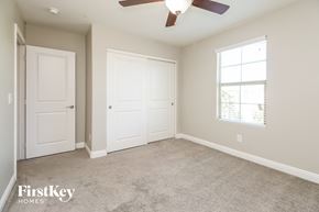 Mesa house for rent - a bedroom with two doors and a ceiling fan