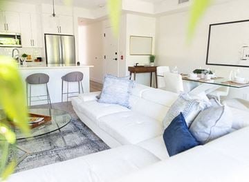 Winnipeg apartment for rent - a living room with a white couch and a glass table