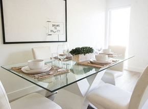 Winnipeg apartment for rent - a white dining room with a glass table and white chairs